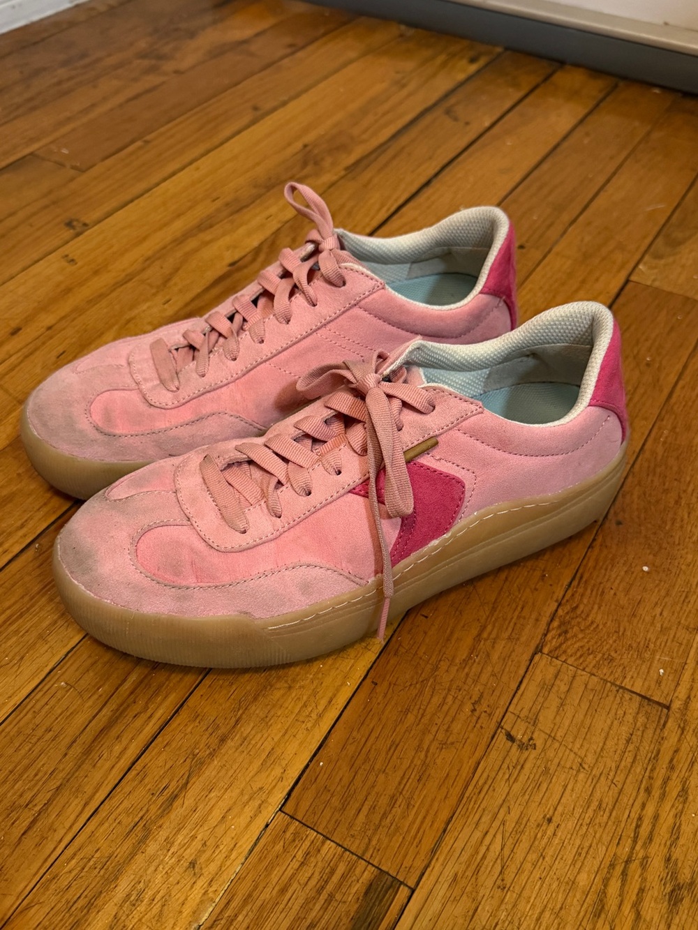 Dirty worn pink suede sneakers